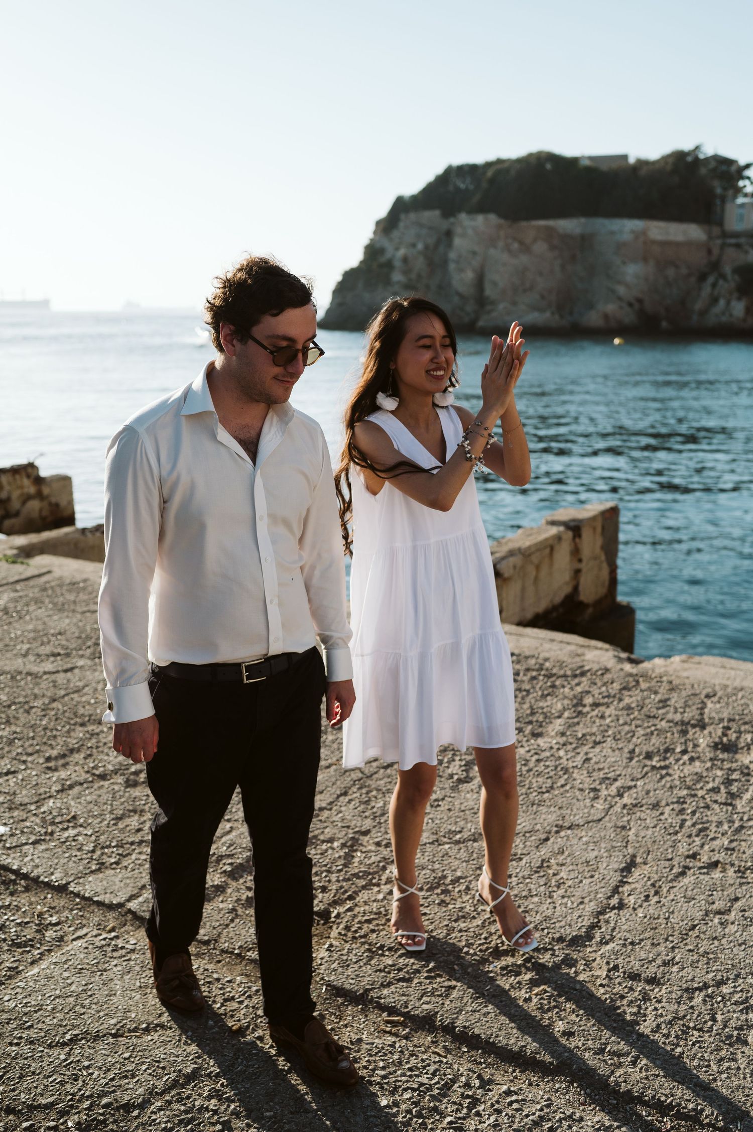 Bride clapping hands in a happy dance at Rosia Bay in Gibraltar