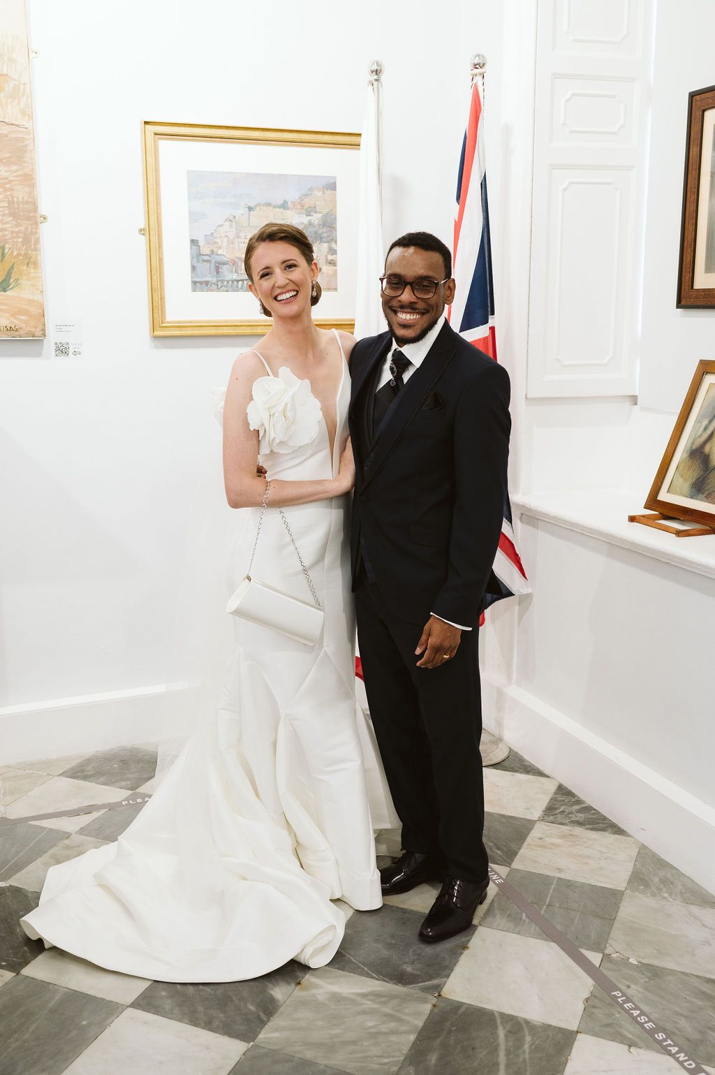 bride and groom after the ceremony with British flags