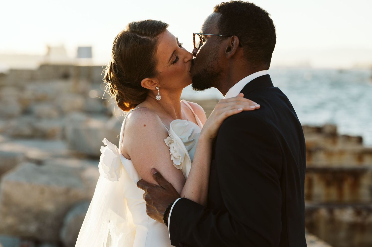 bride and groom kissing at the camp bay