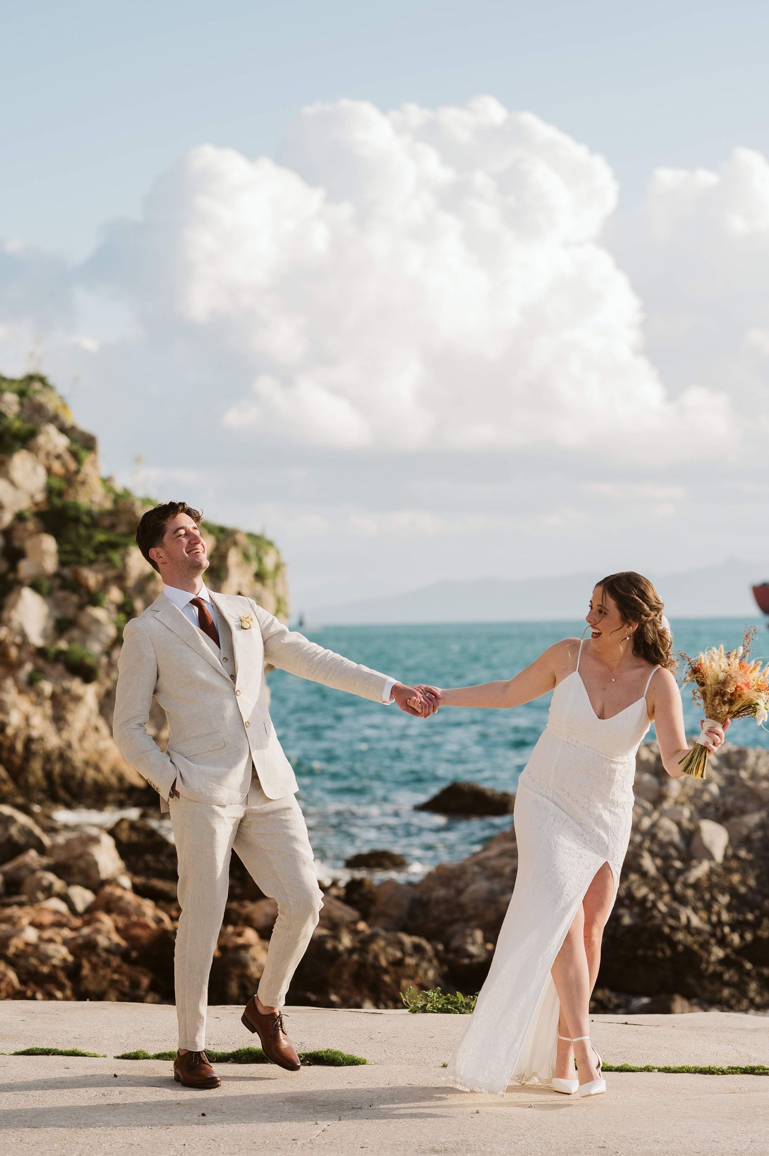 bride pulling the groom for a cool shot at the Rosia bay