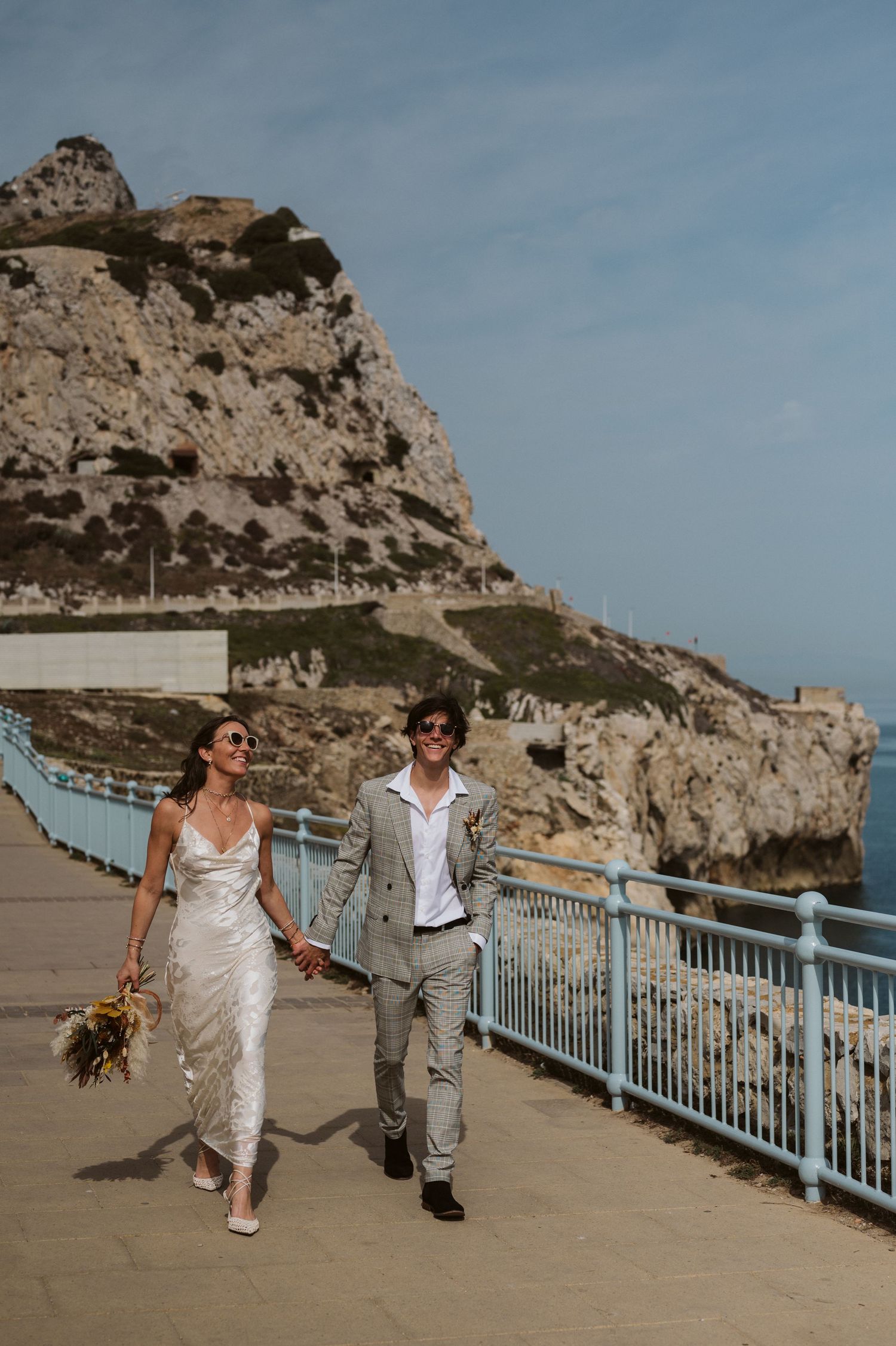 bride and groom walking photo at the Europa Point