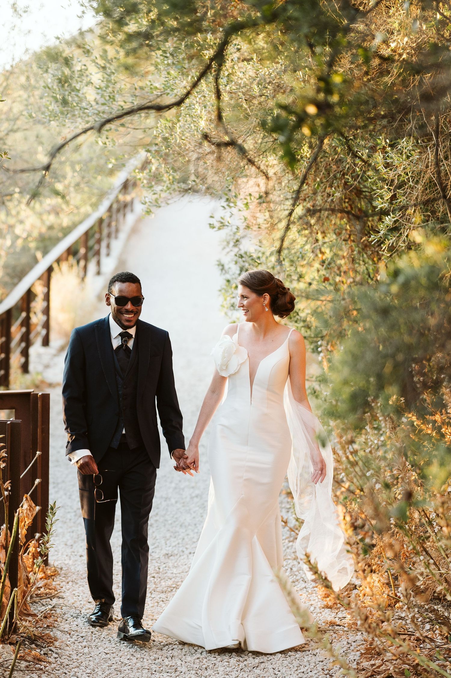 bride and groom walking by the Suspension Bridge in Gibraltar