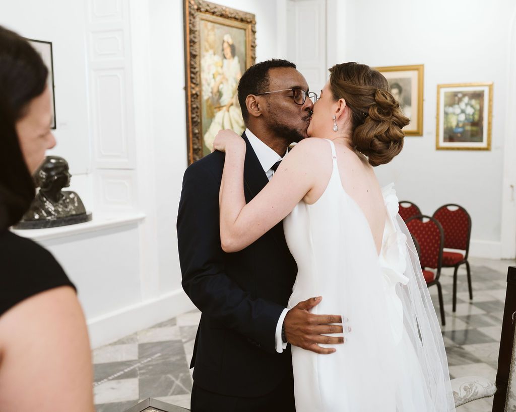Bride and groom kissing at the ceremony at Registry office in gibraltar