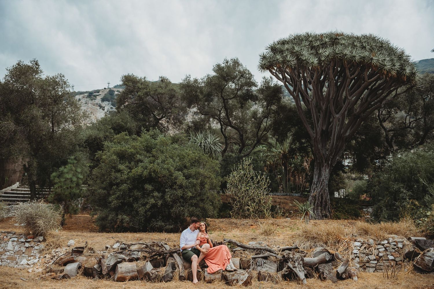 bride and groom sitting in Alameda Gardens posing for a very cool shot in Gibraltar