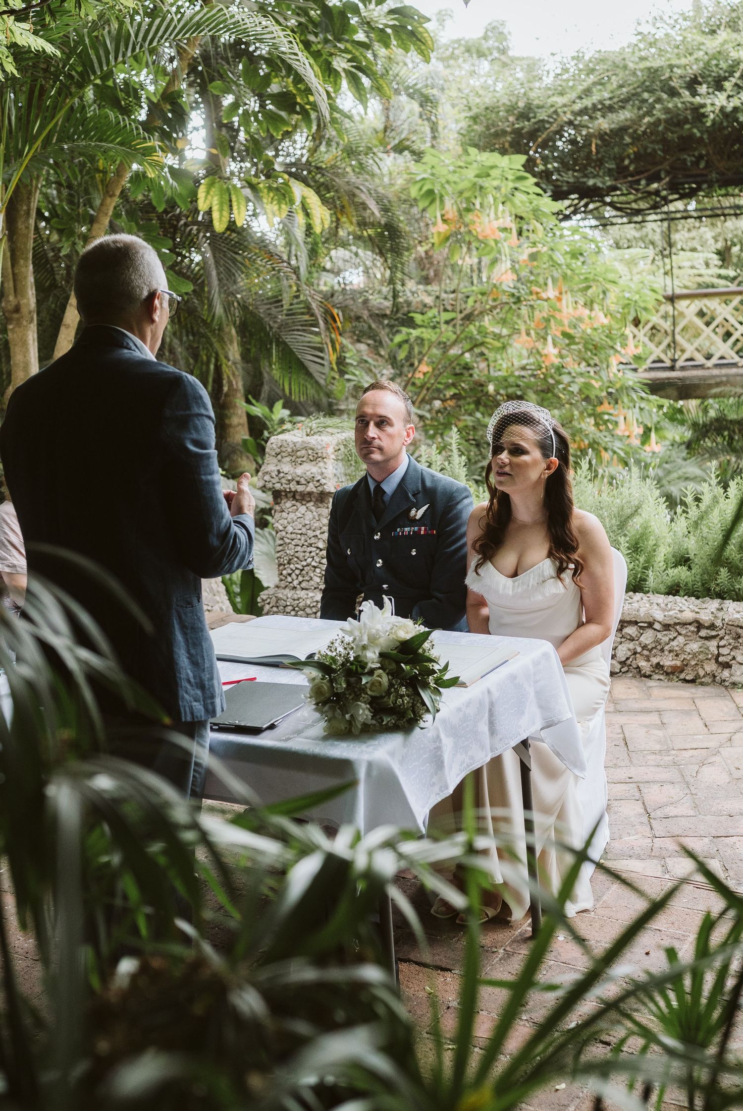 Bride and groom at The Dell ceremony space surrounded by landscaped gardens in Gibraltar