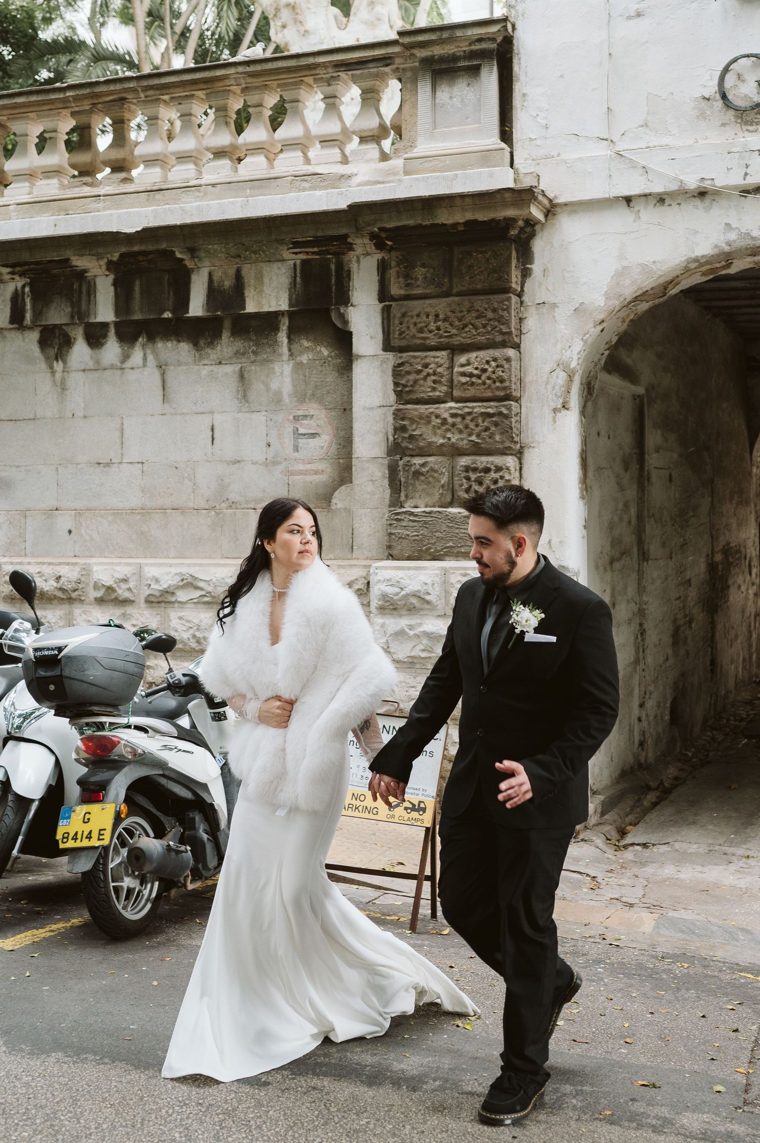 bride crossing the street in the town area in Gibraltar