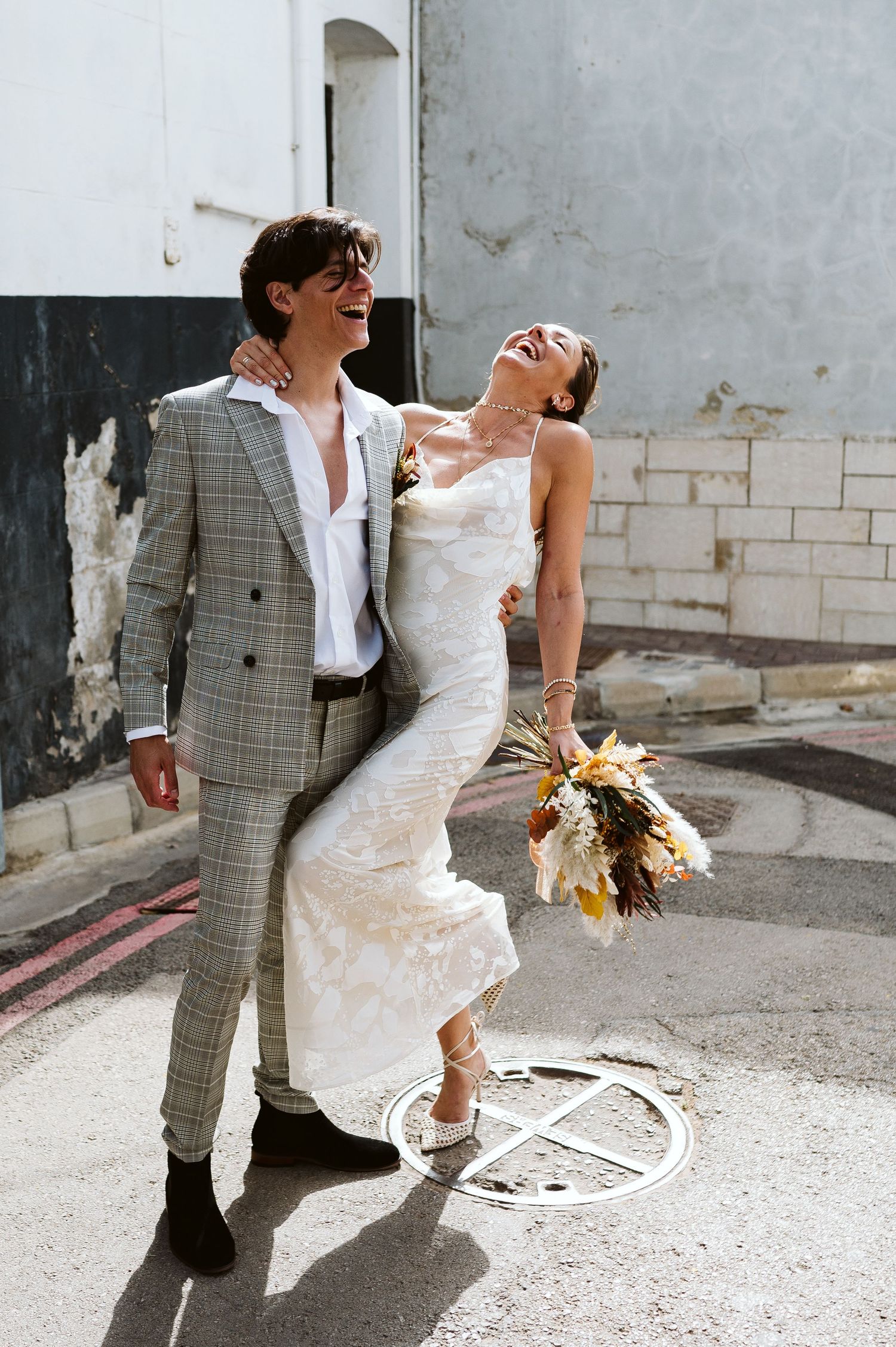 bride leaning back for a model pose outside of the registry office