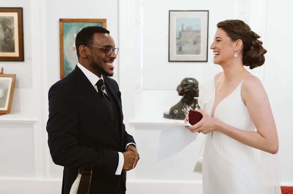 bride and groom laughing at each other
