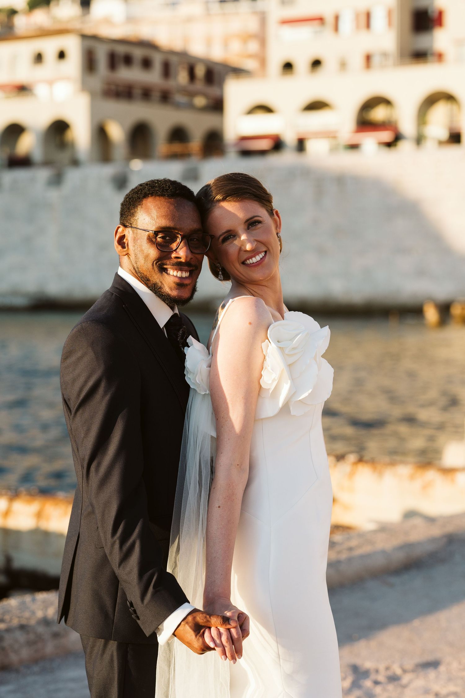 bride and groom smiling for a photo at the Rosia Bay
