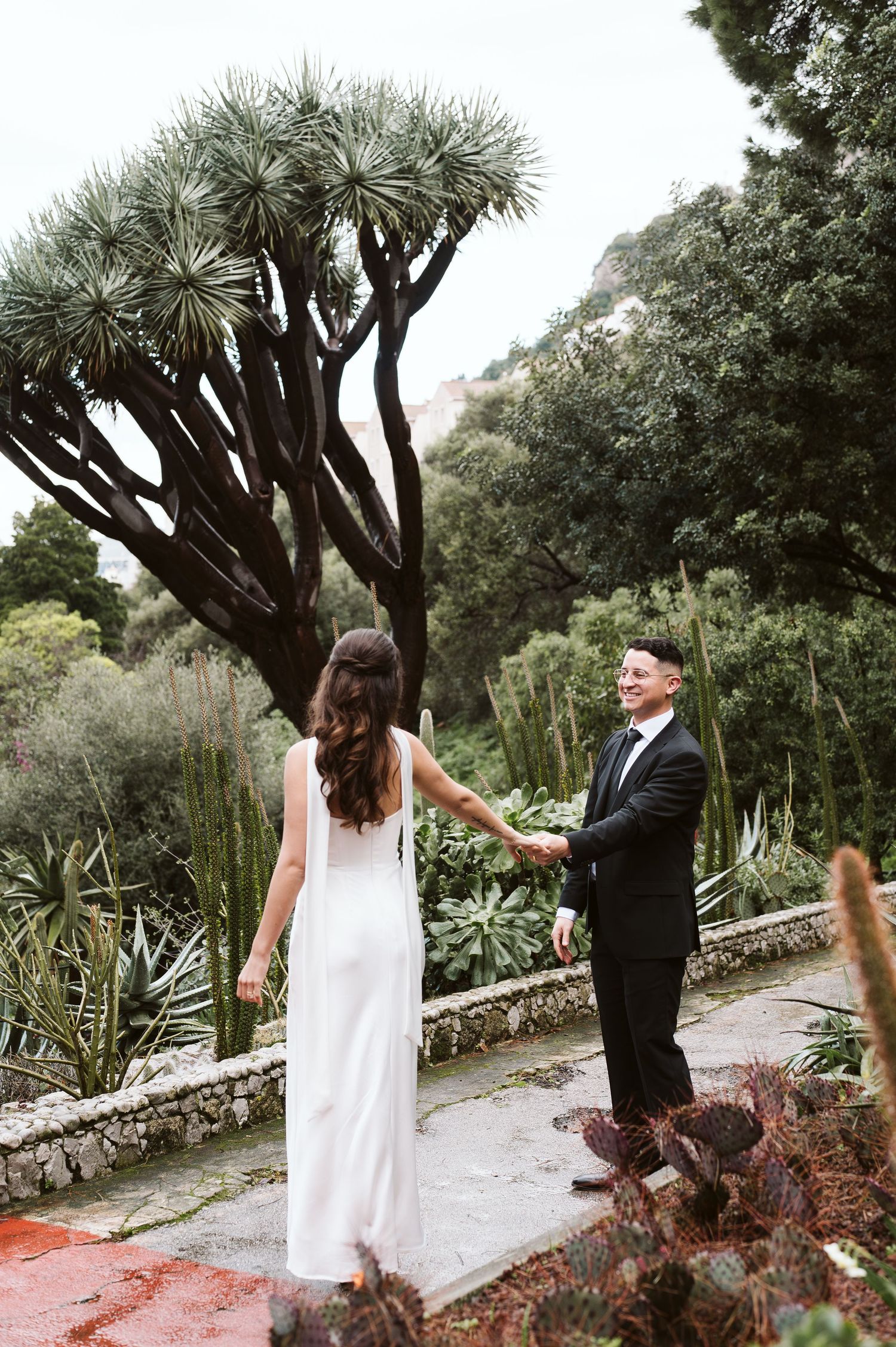 Groom pulling the bride for a nice photo in Alameda Gardens