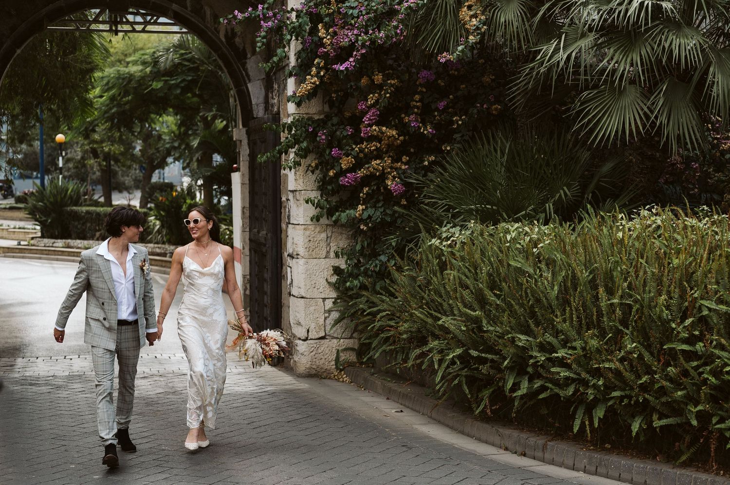 Newly wedded couple walking smiling