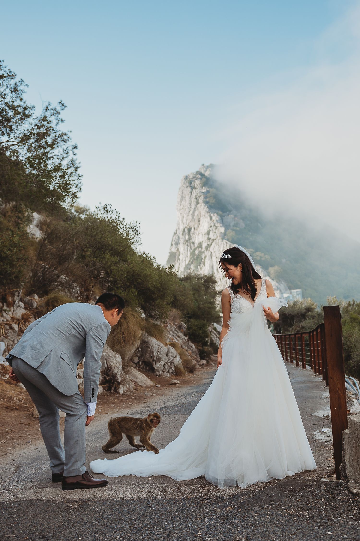 Bride and groom at sunrise session with a monkey at the TOP of the Rock in Nature Reserve