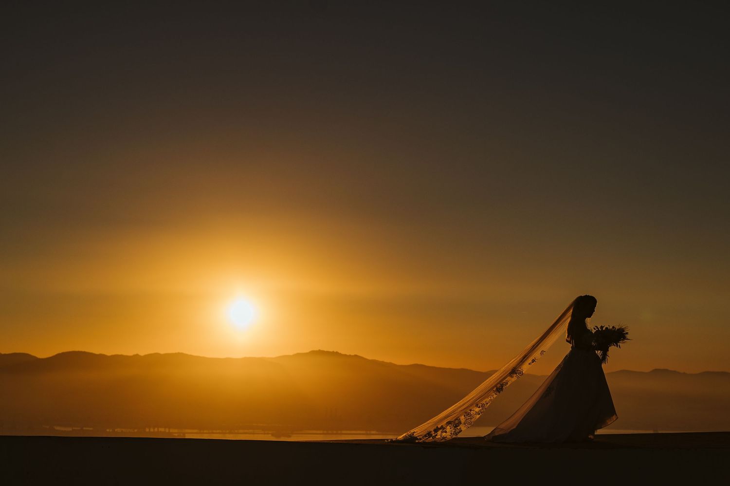 Bride walking in the last sunrays