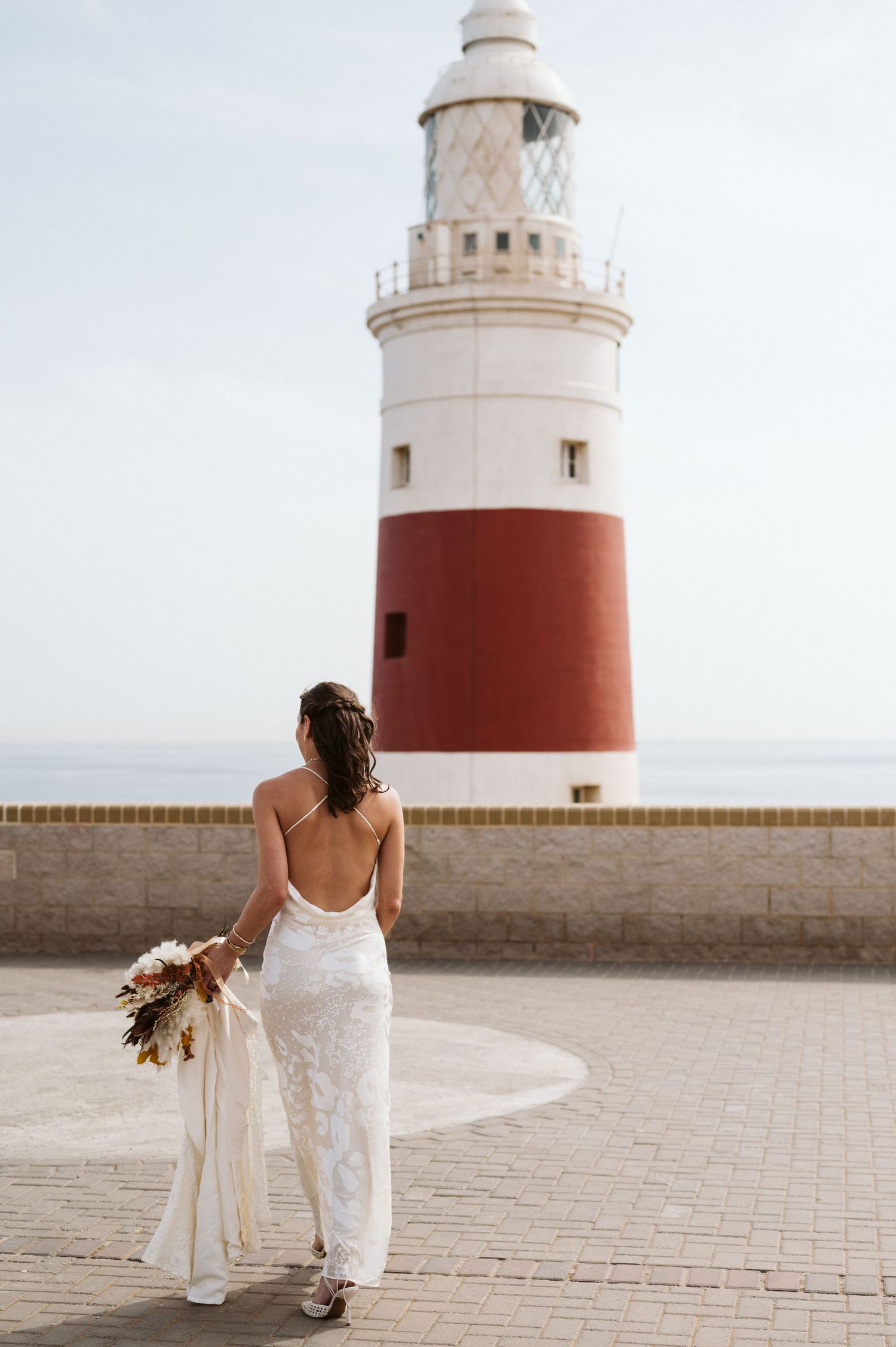 Bride at the Europa Point walking towards the Lighthouse