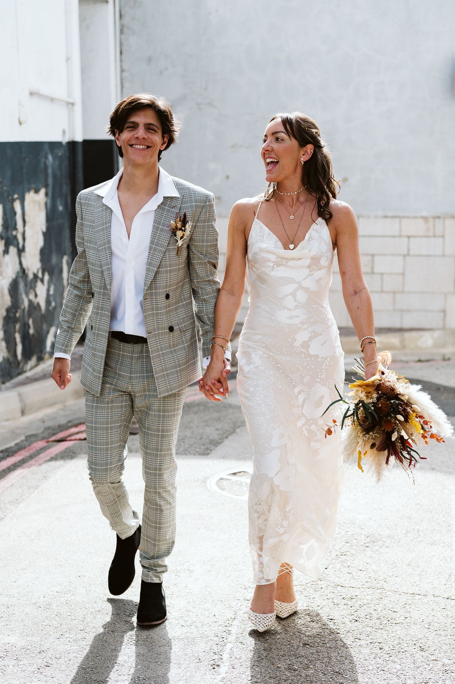 bride and groom walking holding hands straight after the ceremony