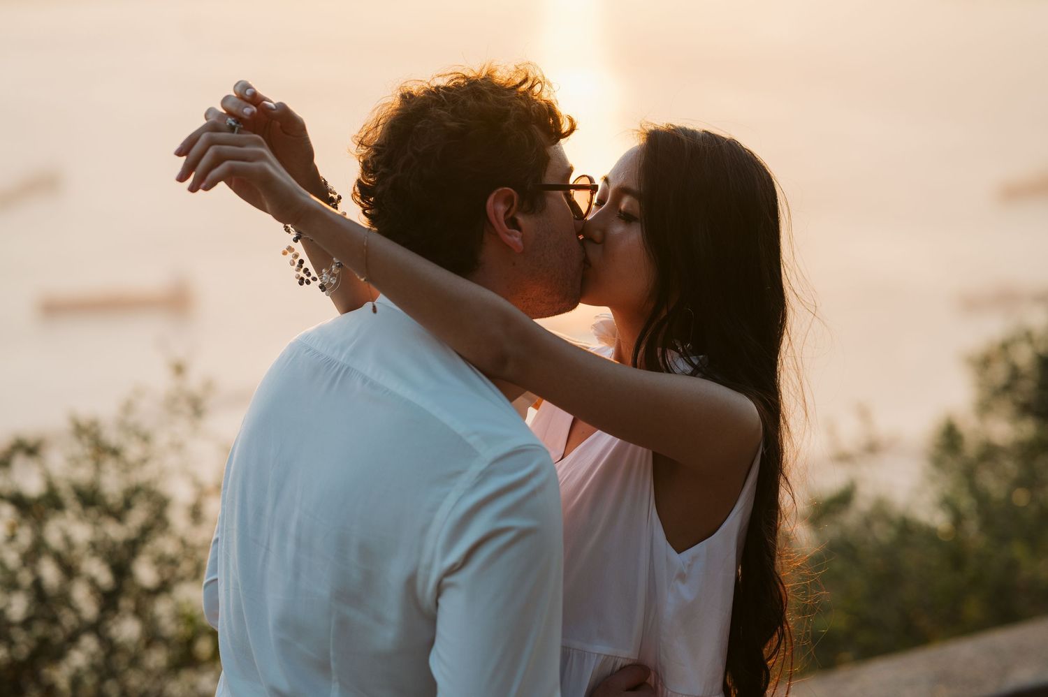 Bride and groom kissing at the sunset time