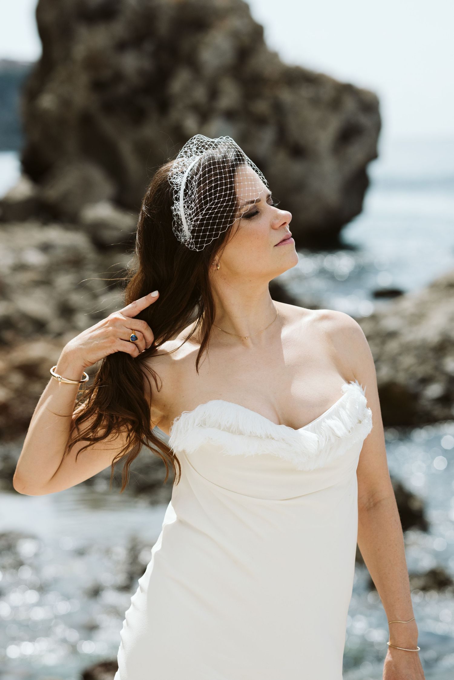 Bride holding her hair posing for a cool photo