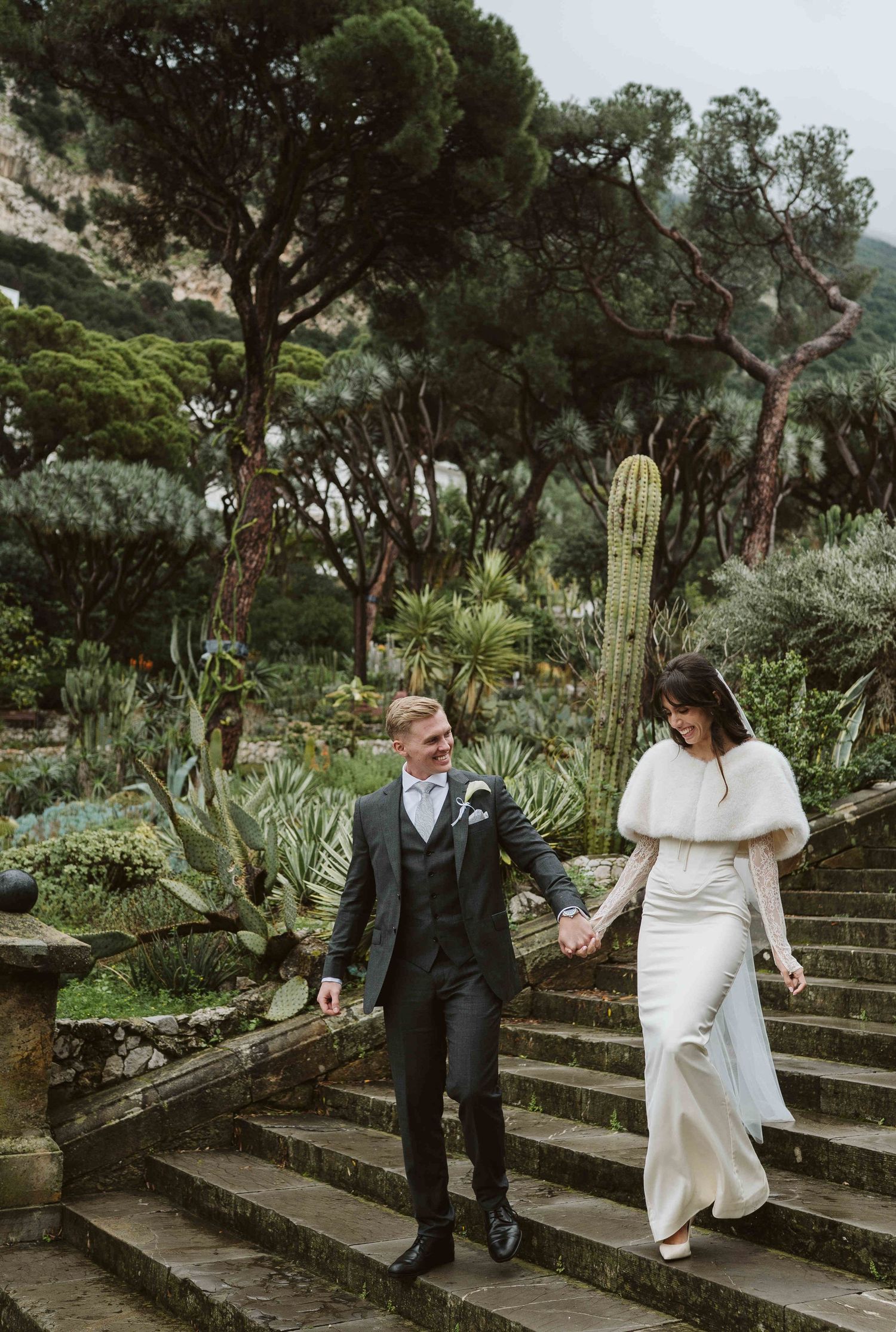 Bride and groom walking in Alameda Gardens. Bride is wearing House of CB dress