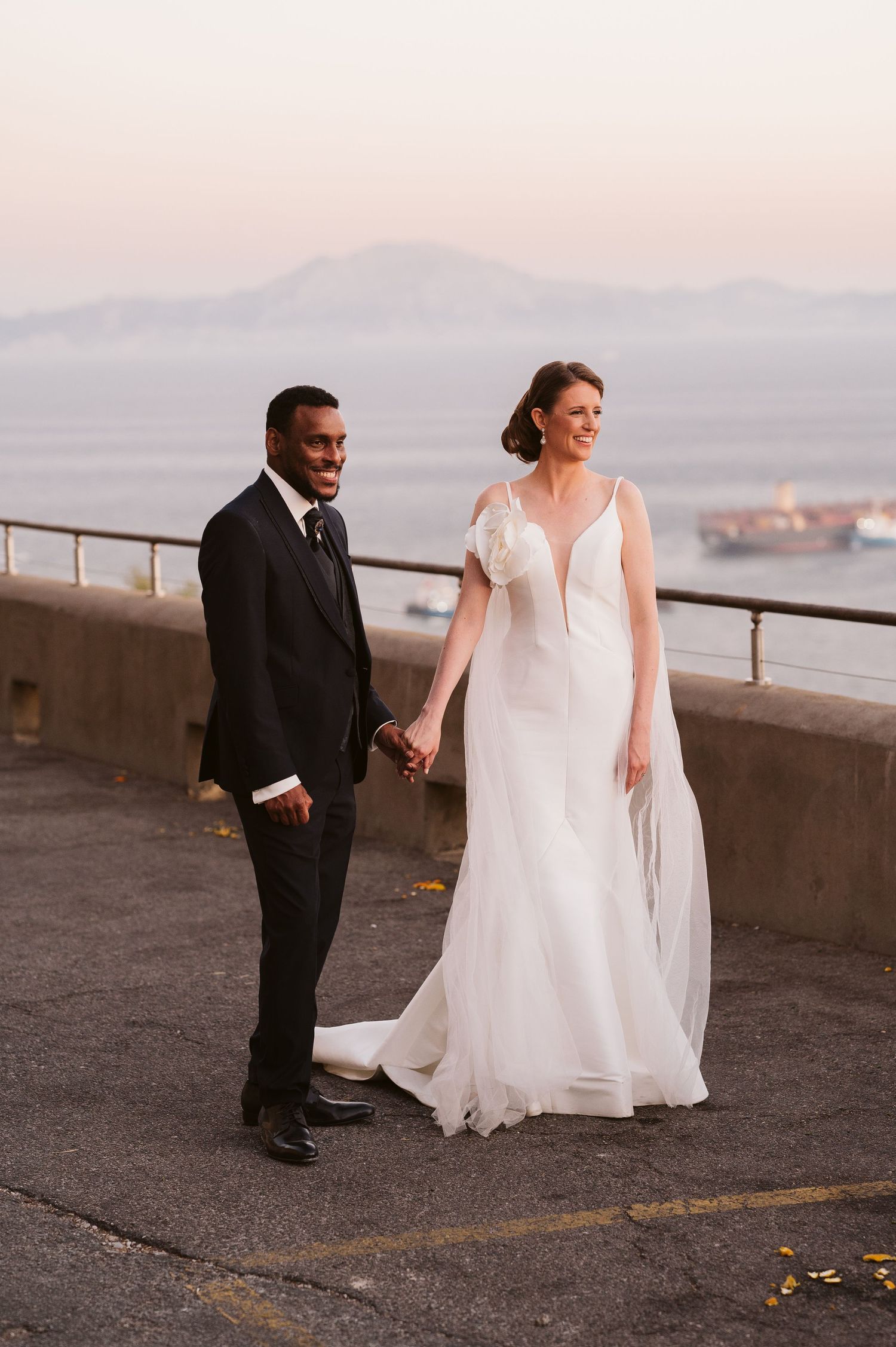 Bride and Groom on Top of the Rock looking to the View