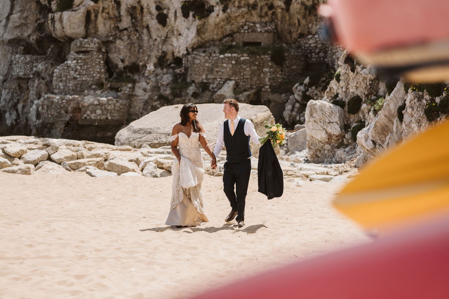 Wedding couple walking on the beach in Gibraltar