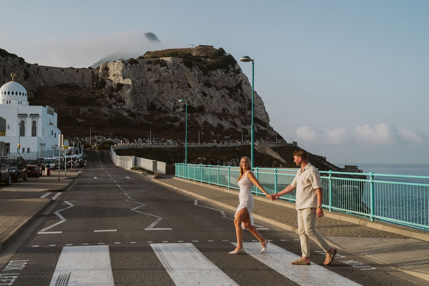 bride and groom crossing street at Europa Point
