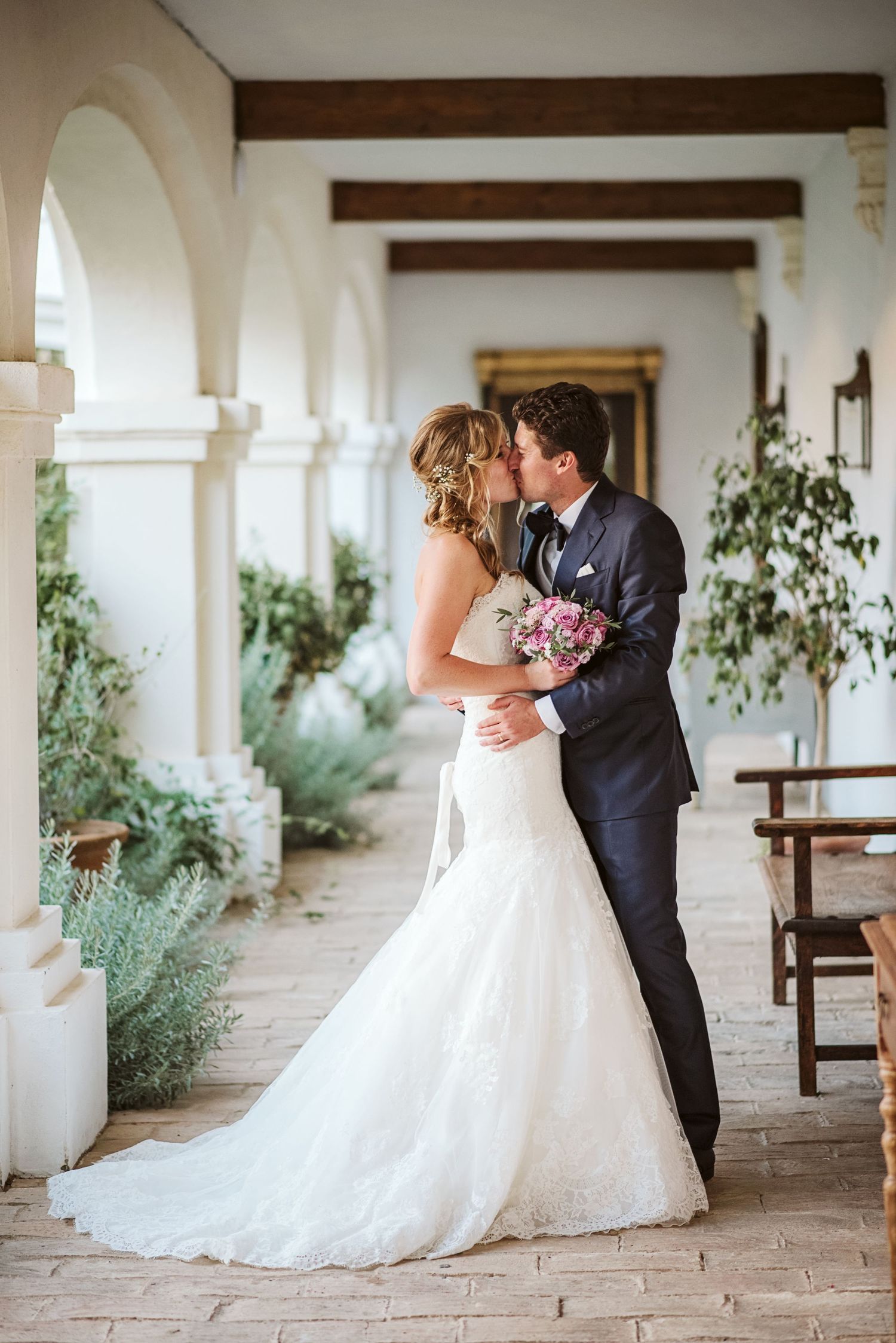 bride and groom kissing for a portrait