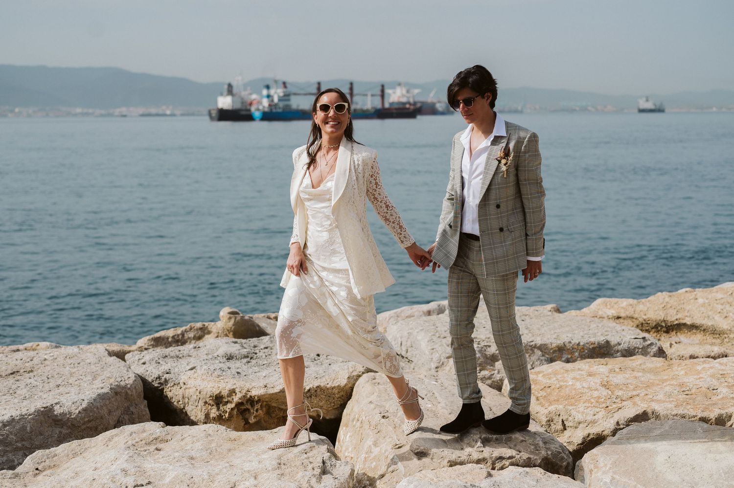 Bride and groom walking at Camp bay stones