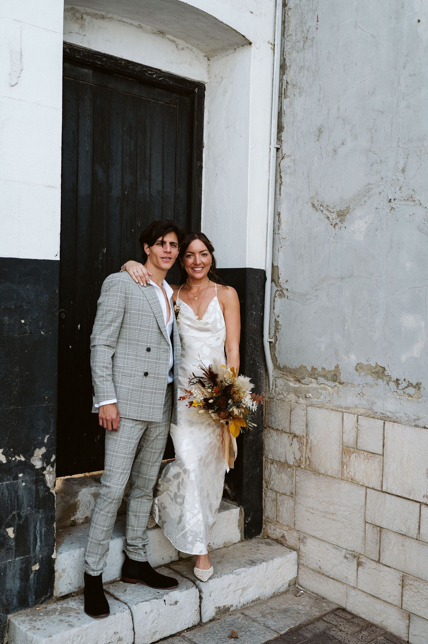Bride and groom posing for a photo outside