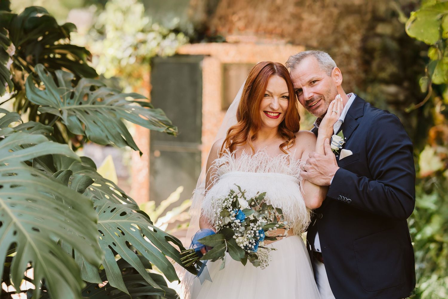 Outdoor wedding ceremony at The Dell in Gibraltar Botanic Gardens with curved stone seating and greenery