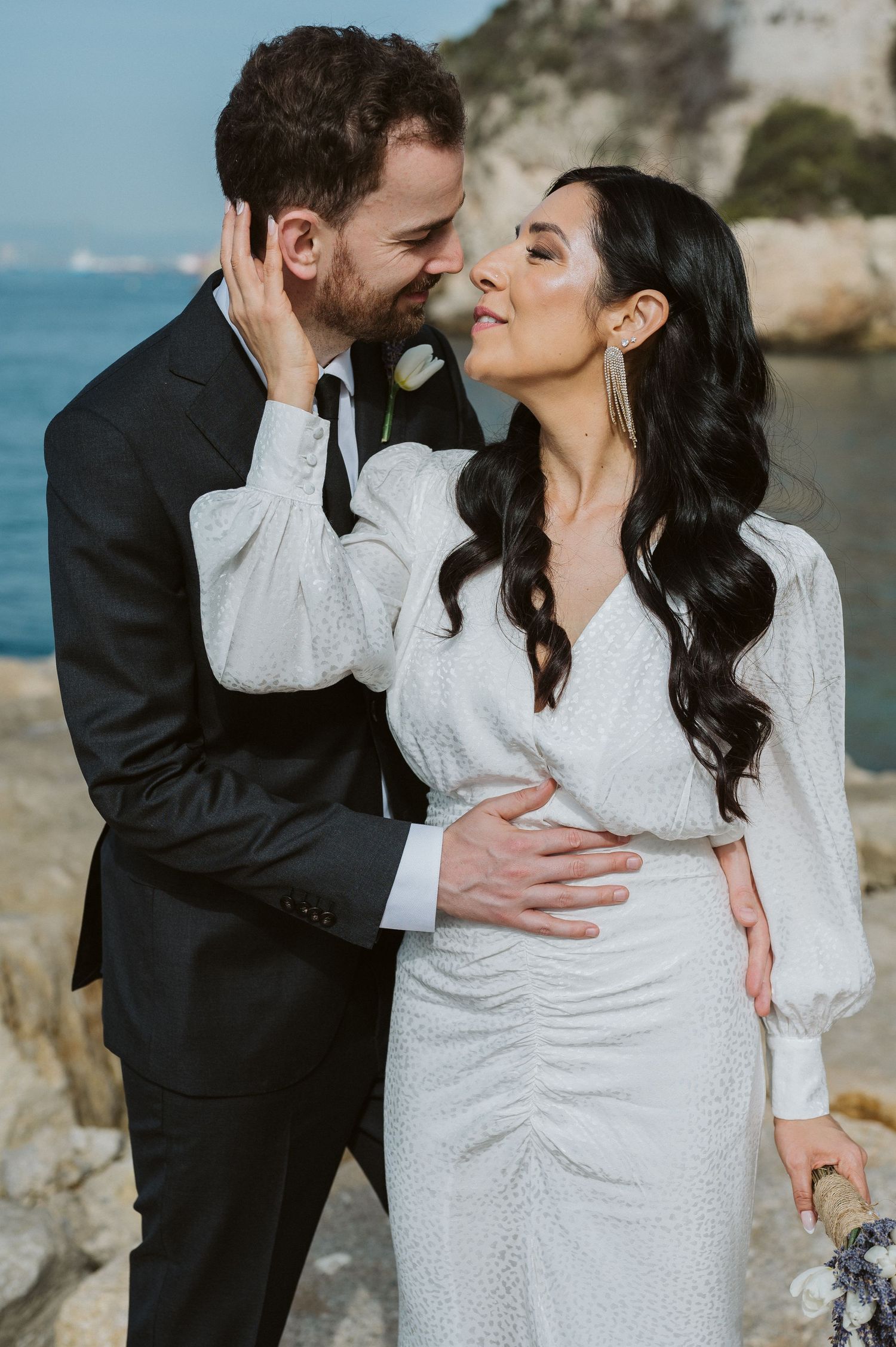 Bride caressing groom at Camp Bay