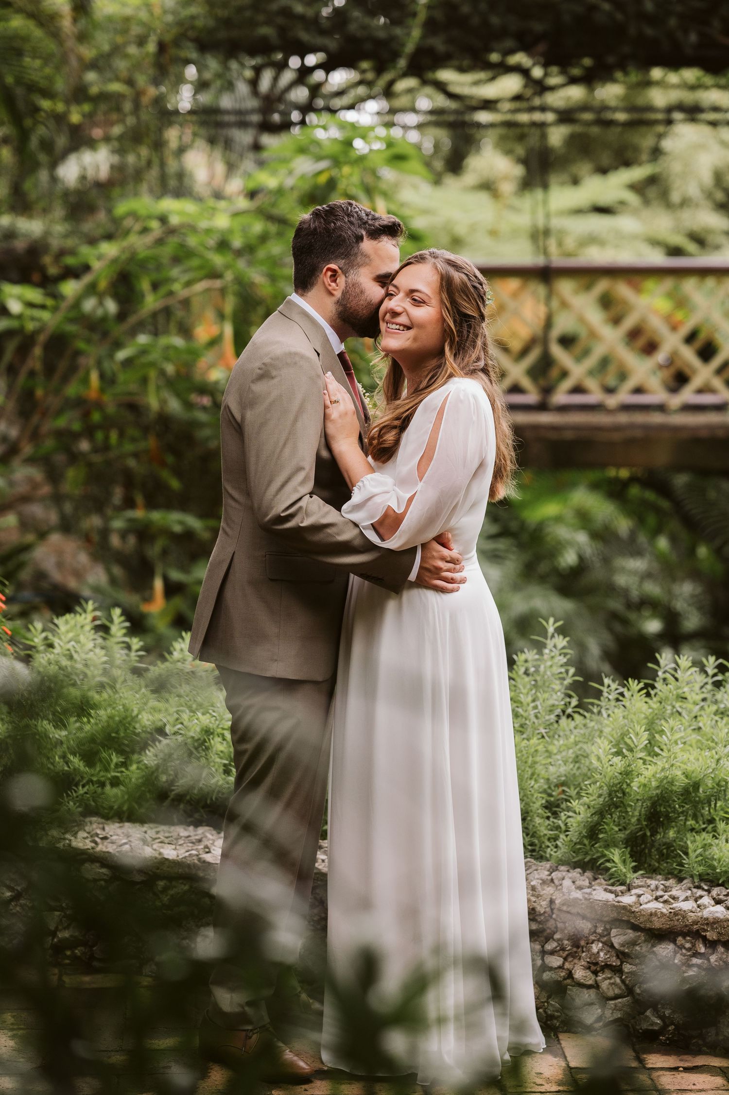 Bride and groom smiling at the ceremony spot at the Dell in Alameda Gardens