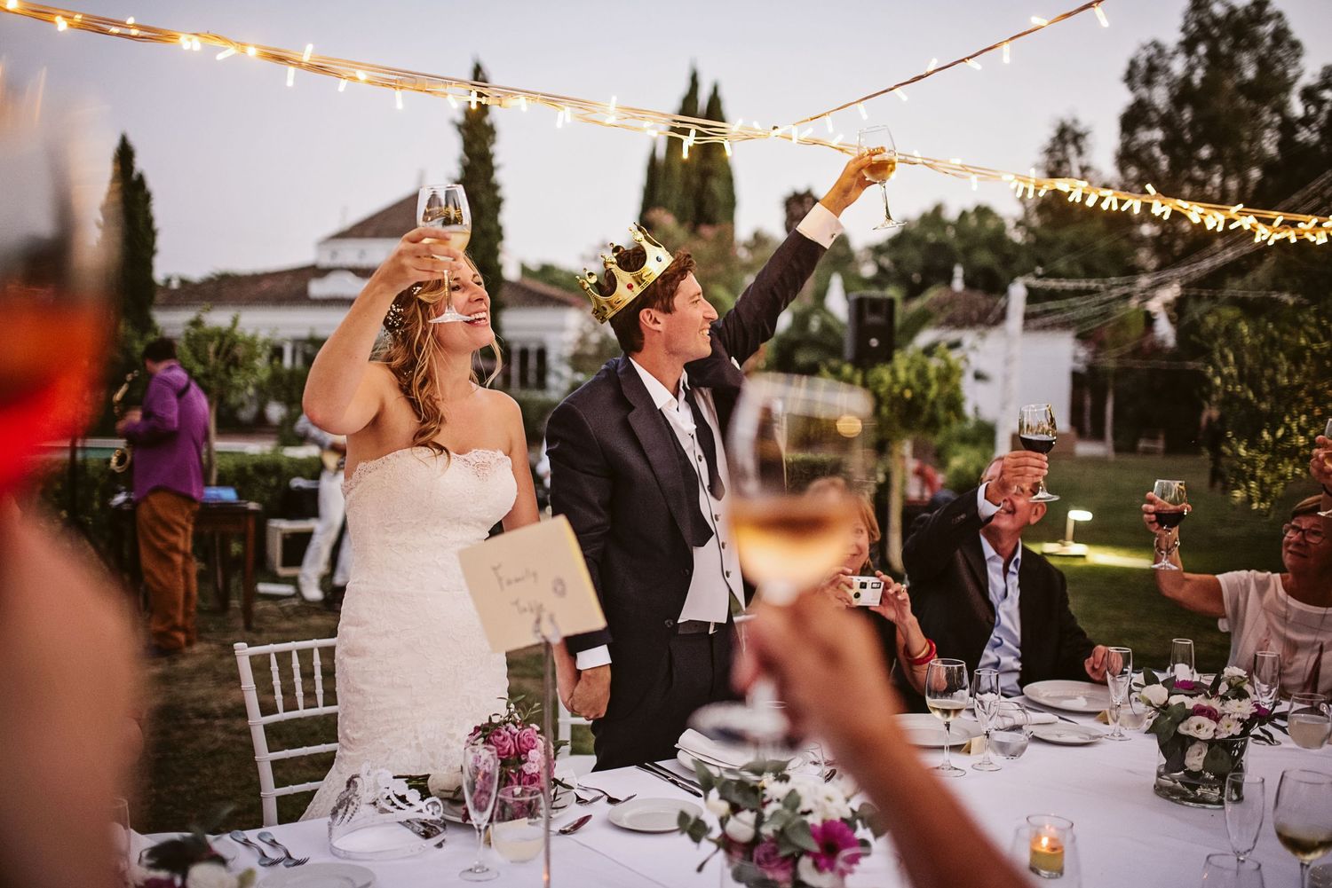 Groom and bride cheering for a toast
