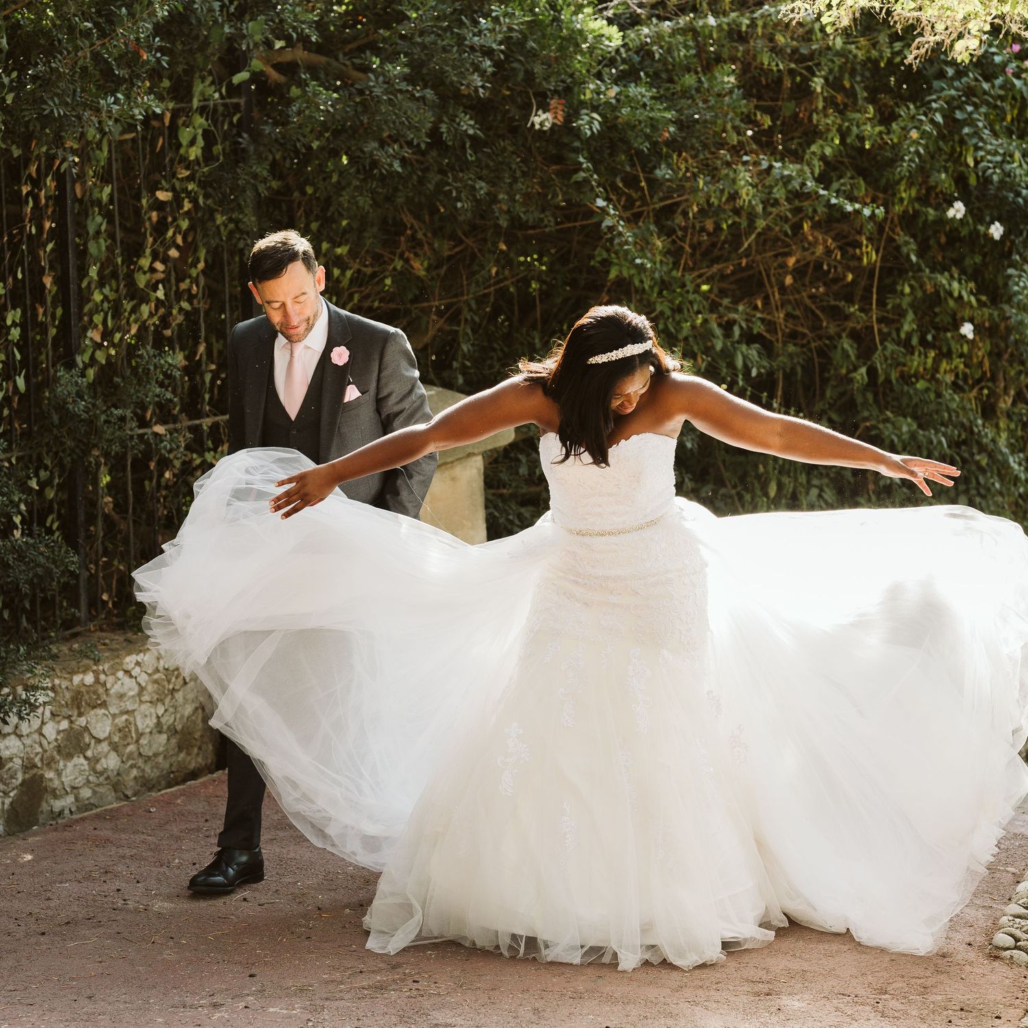 Bride pulling her dress in a beautiful sunlight at Alameda Gardens