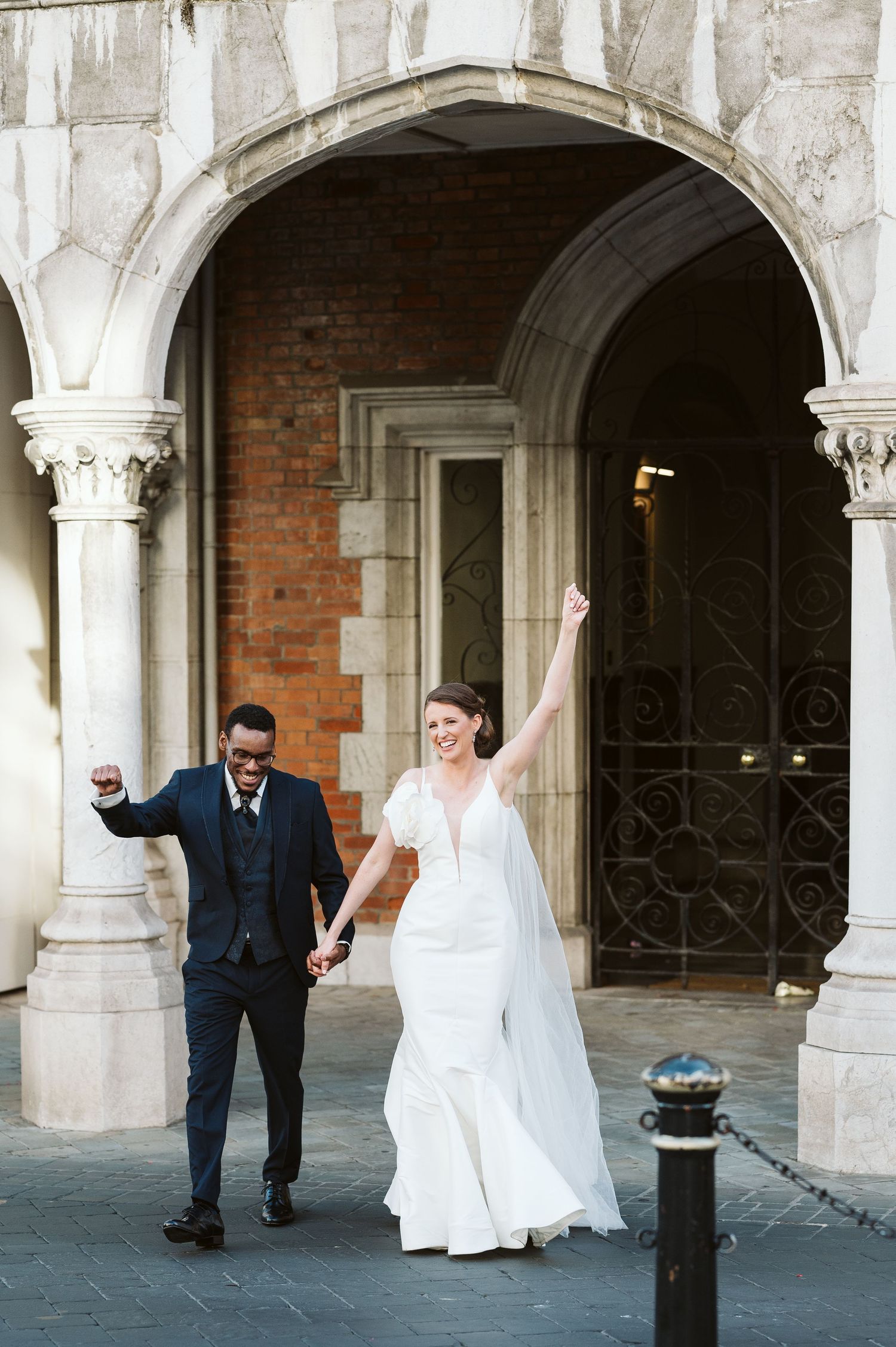 Bride and groom walking at the Convent being very happy