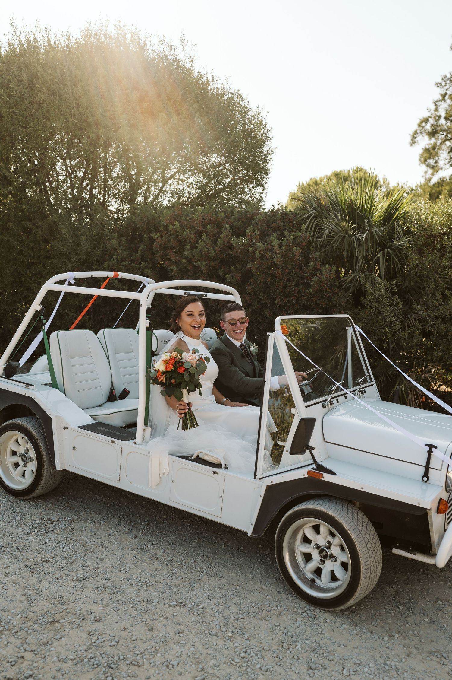 Newlyweds riding in a vintage jeep during their wedding in Sotogrande