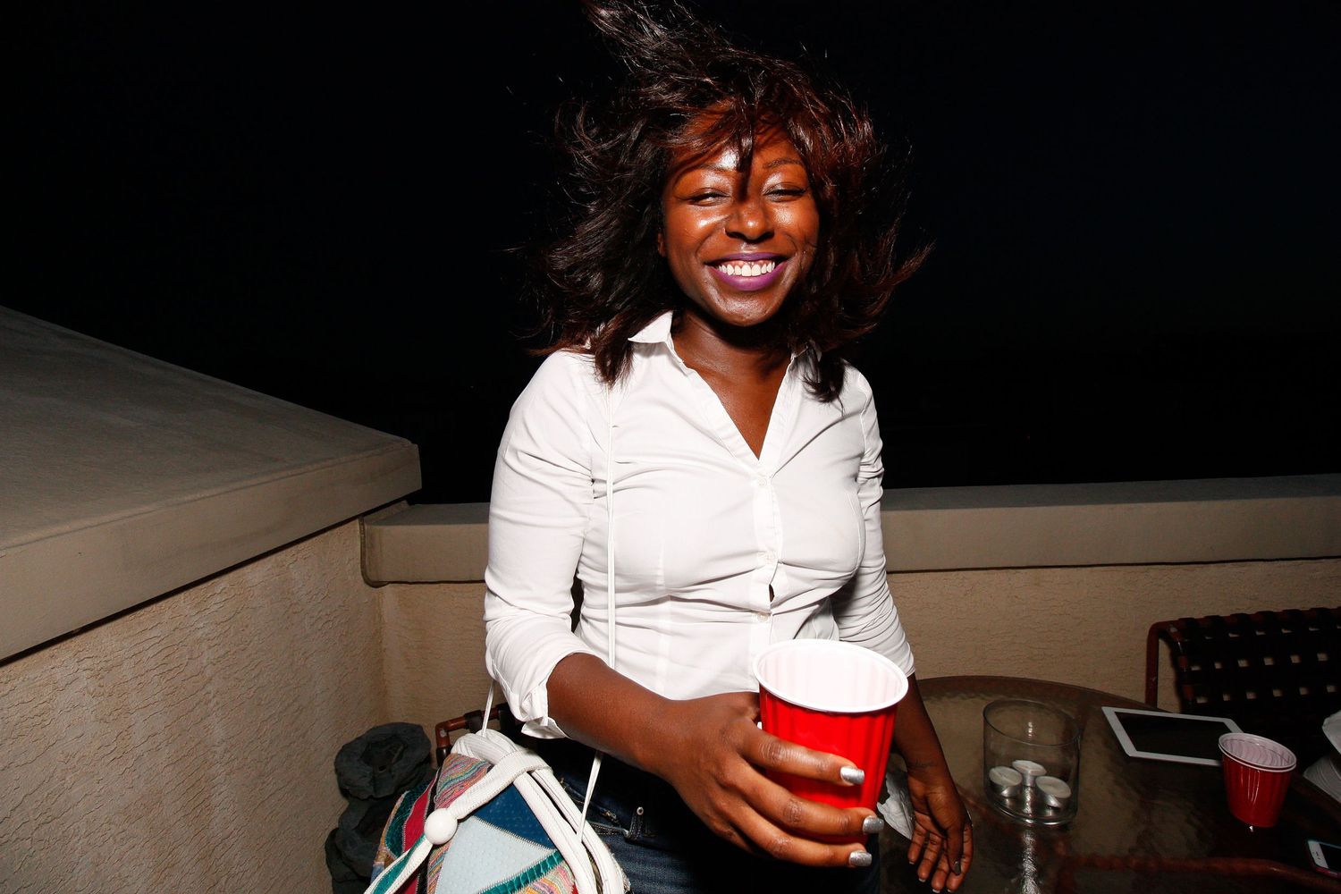 Woman enjoying drinks and conversation at a social gathering.