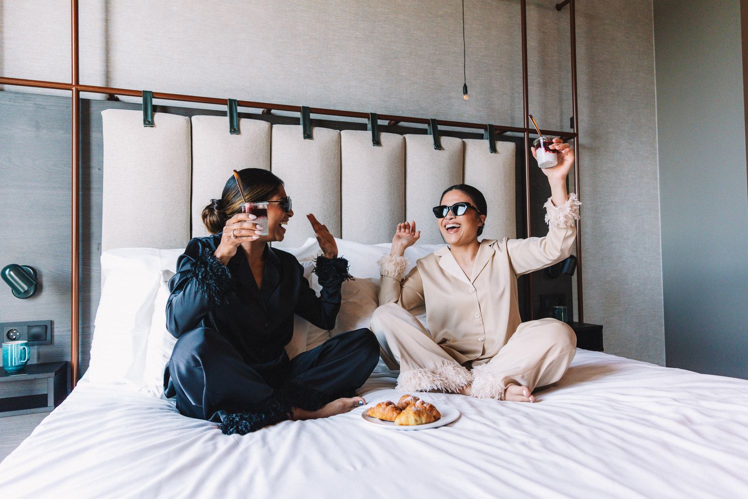Candid moments captured on white bedding in natural light setting.