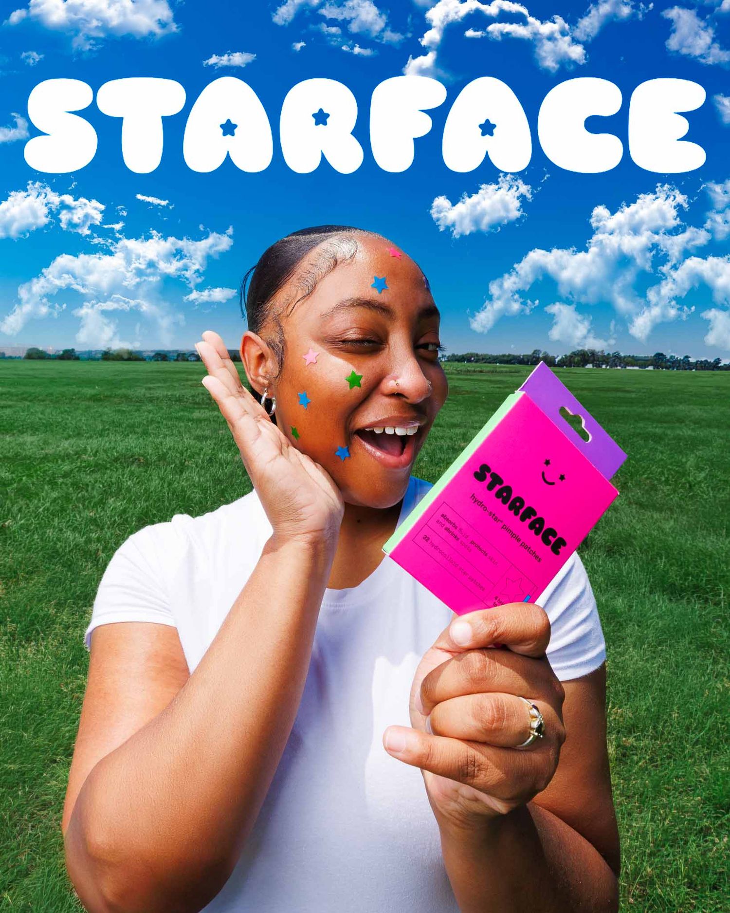 Woman holding Starface acne patch packaging outdoors, wearing colorful star-shaped pimple patches on her face.