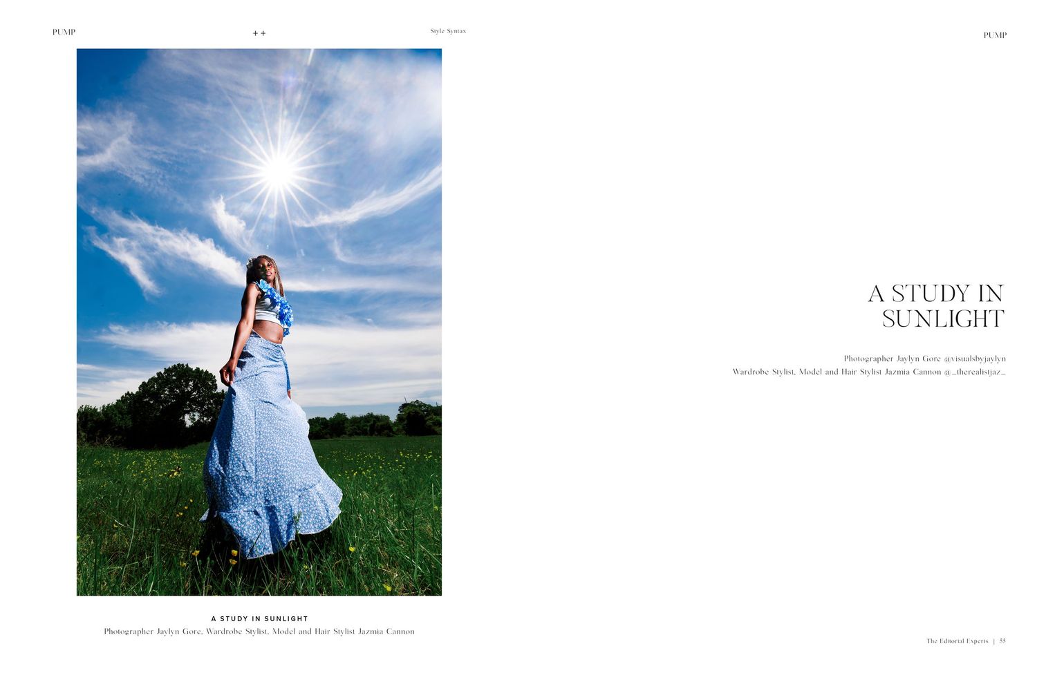 A woman in a flowing blue gown stands in a sunlit green field under a dramatic sky with radiant sun.