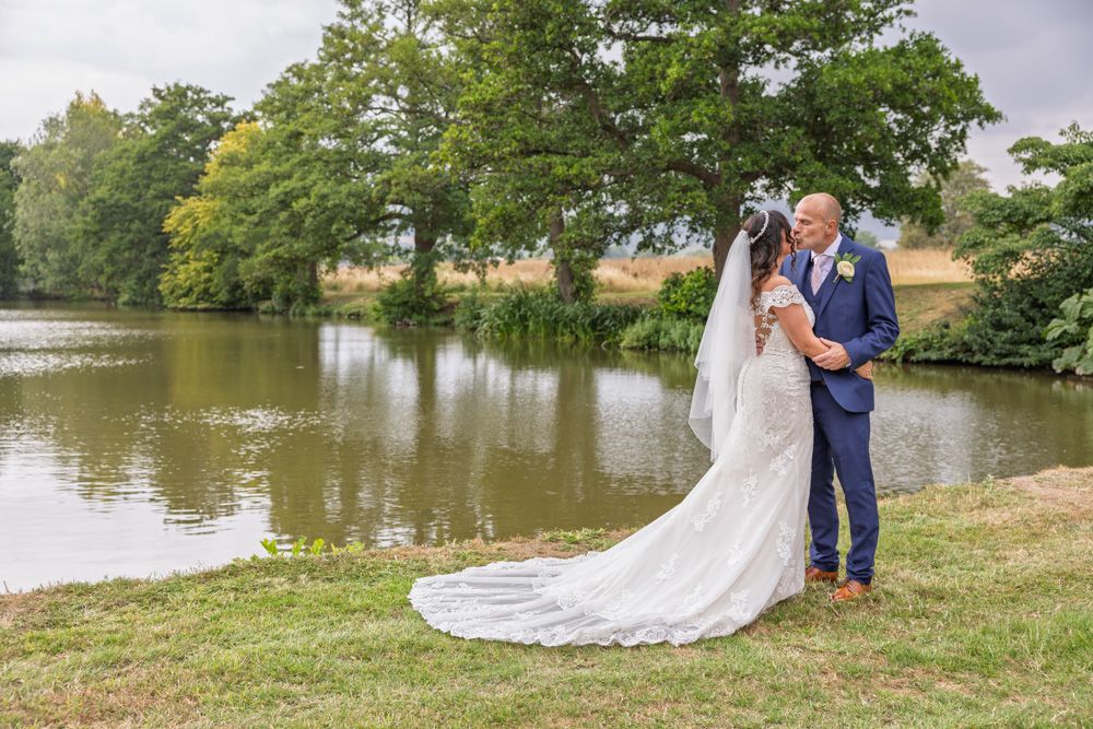 Bride and Groom relax by the lake