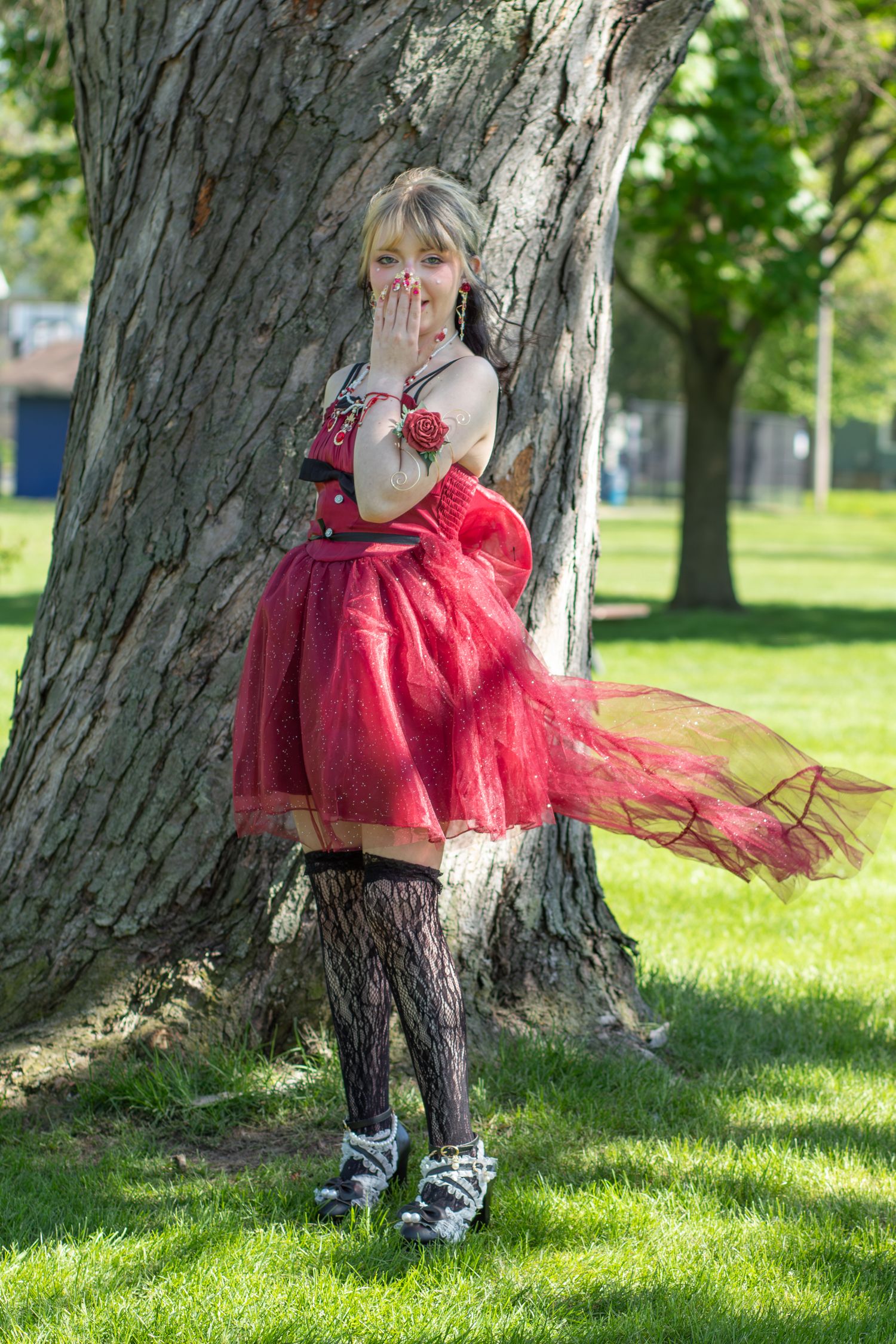 Photoshoot posing in prom dress at a park