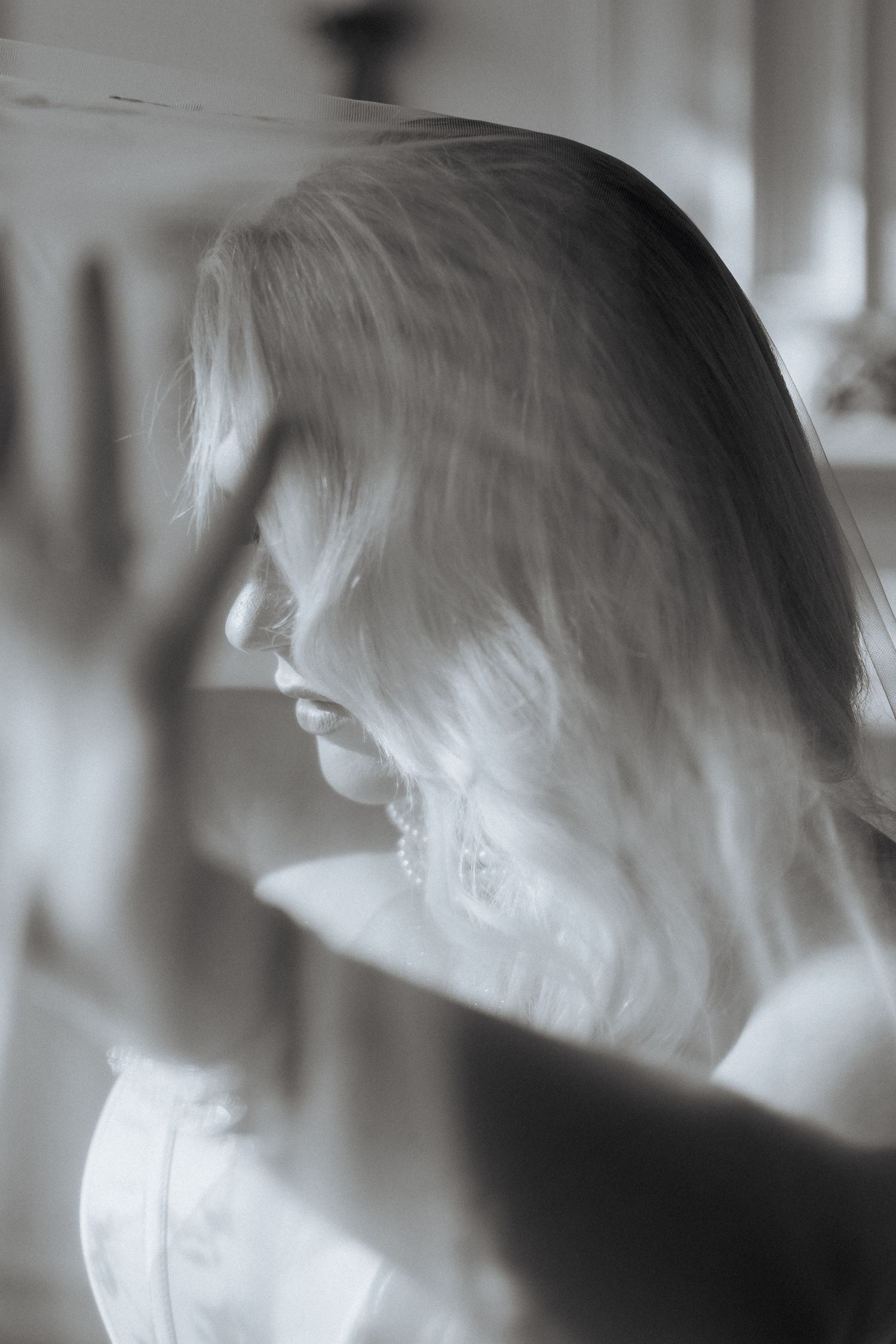 A dreamy black and white profile portrait showing long hair and soft lighting creating an ethereal atmosphere.