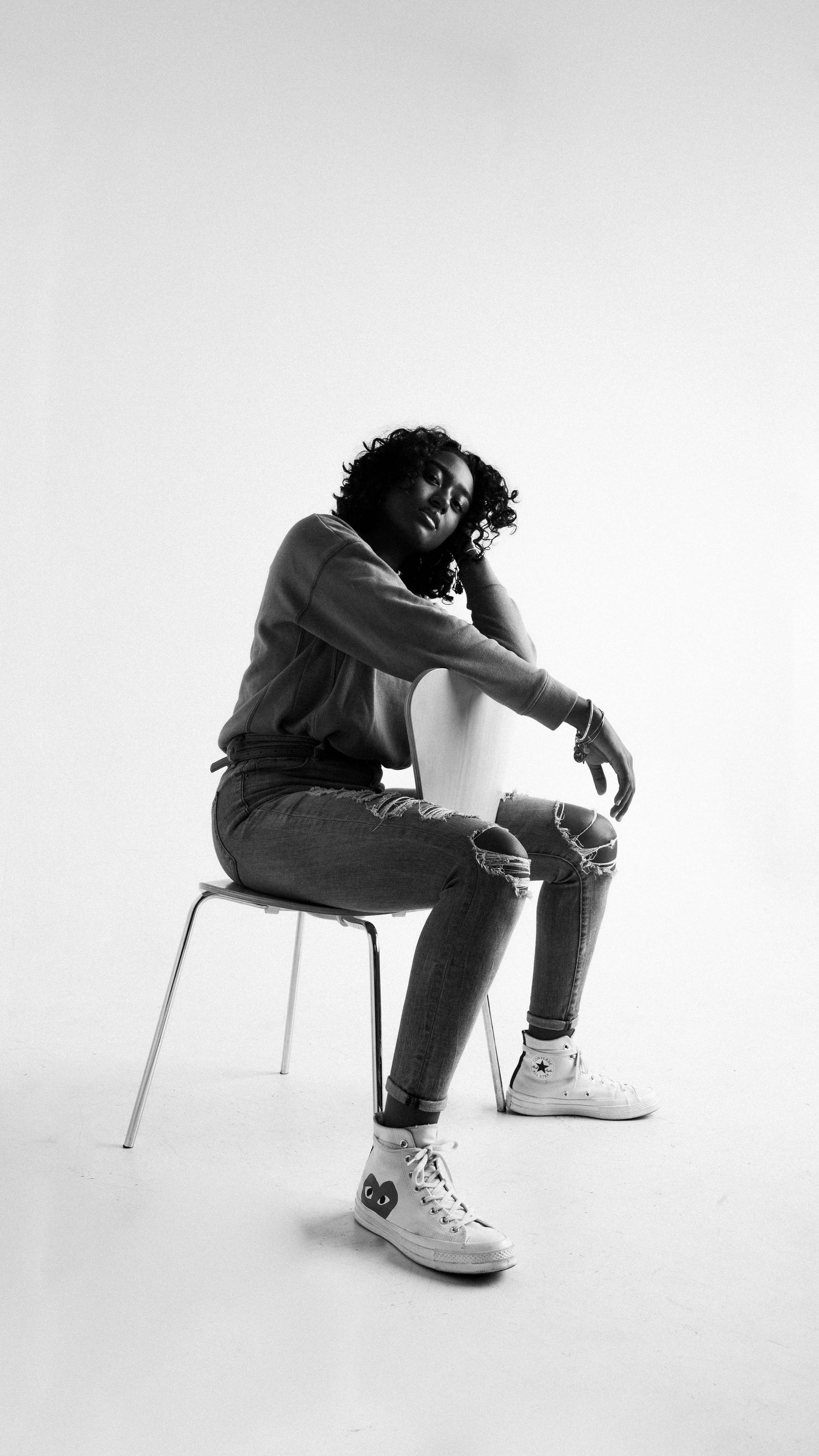 girl sitting backwards in chair in the studio