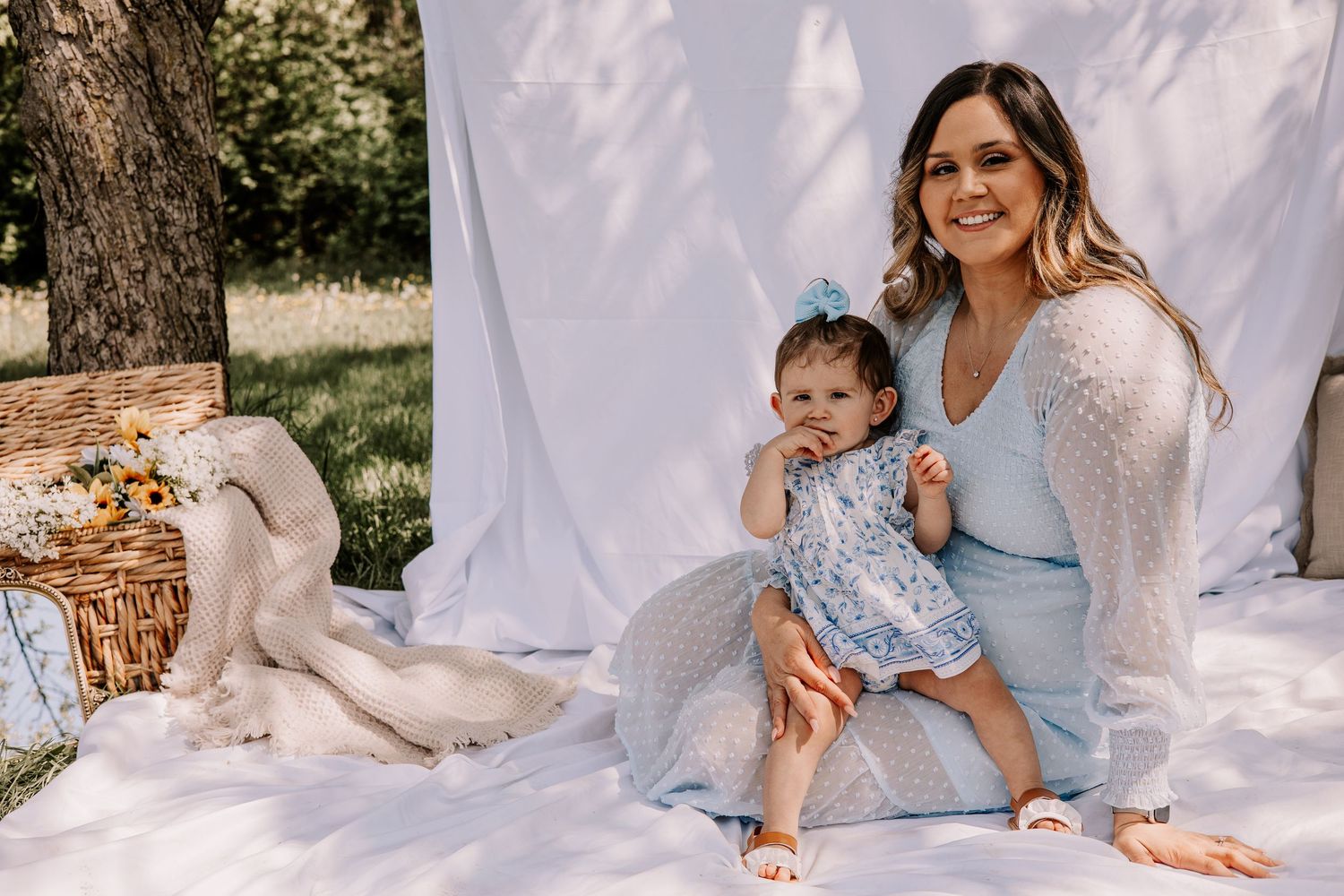 A series of outdoor family portraits with white fabric backdrop showing intimate moments between loved ones in natural lighting.