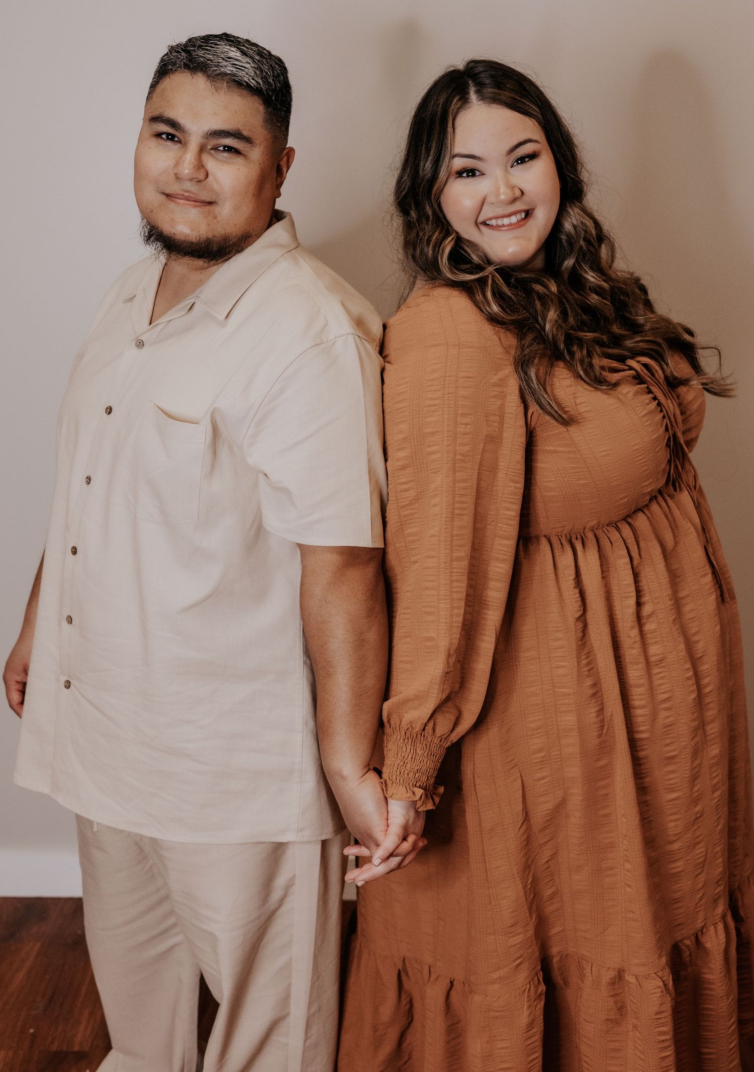 A couple in coordinating brown and white outfits poses together in a series of candid lifestyle photos.