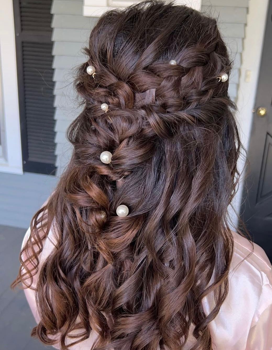 Elegant updo hairstyle with pearl accessories and braided details shown from multiple angles.