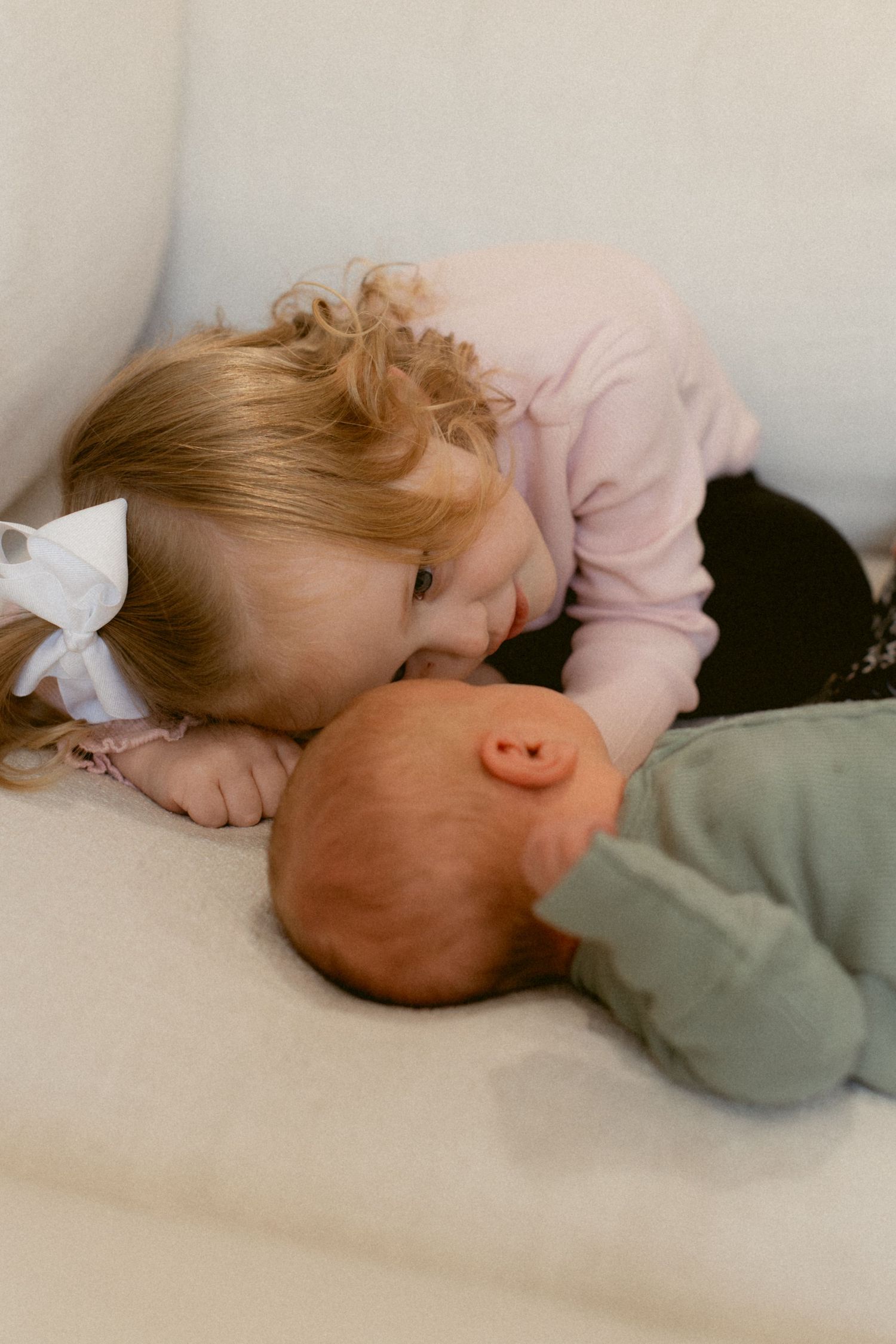 A series of five connected images showing a young child sleeping peacefully on a white surface.