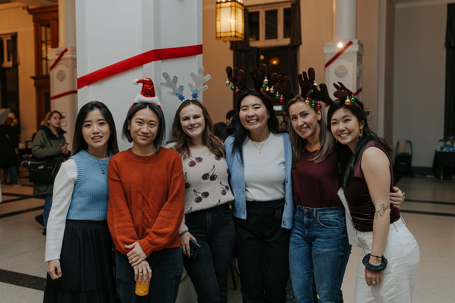 Group of friends gathering in a warmly lit indoor space.