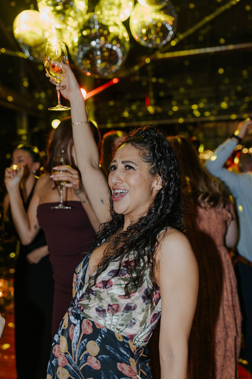 Guests dancing and celebrating at a lively evening wedding reception.