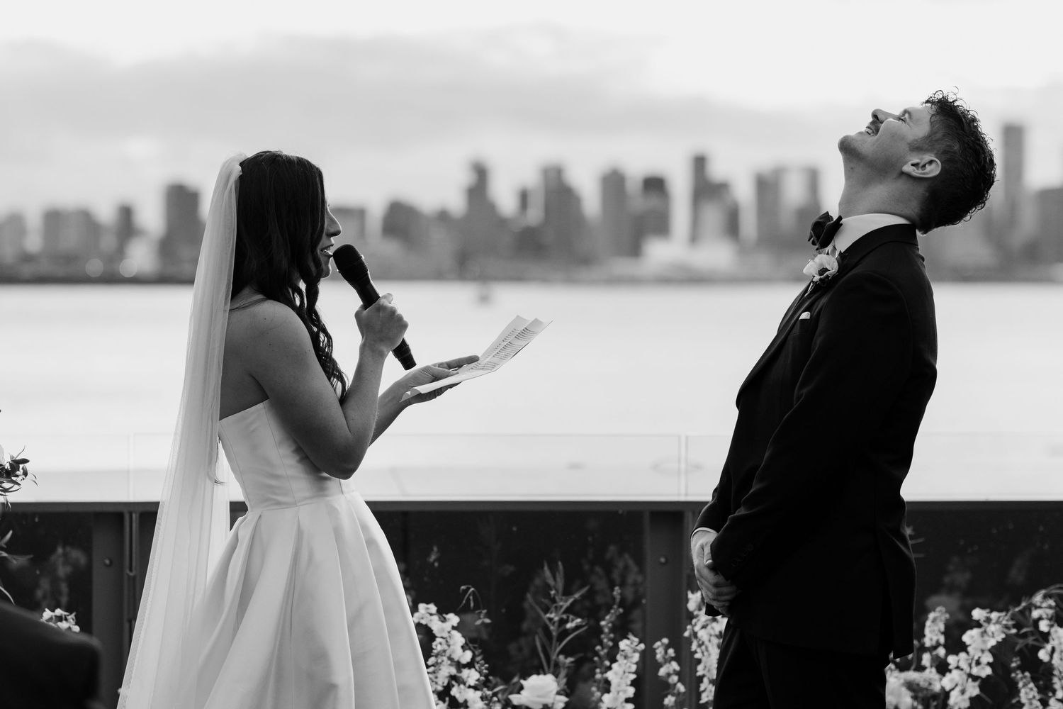 Black and white wedding ceremony moments with city skyline visible through windows.